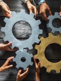Hands fitting metal gears together