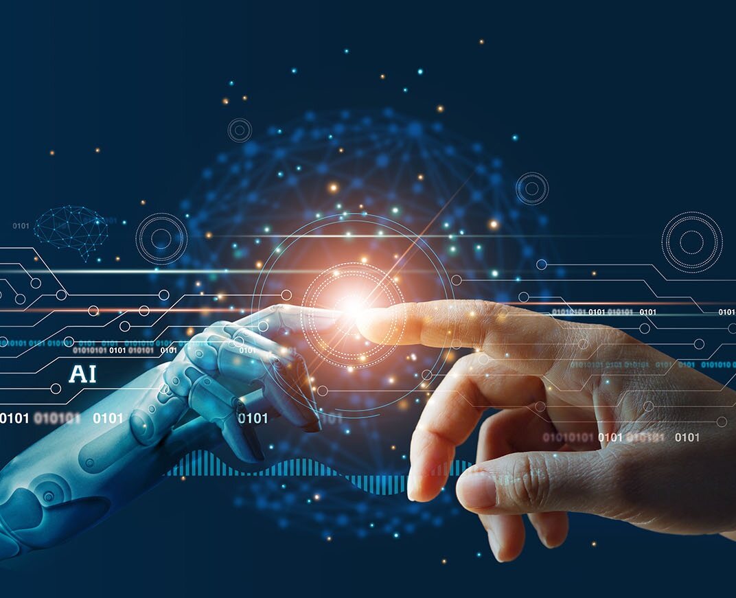 A robotic hand and a human hand reaching toward a point of light